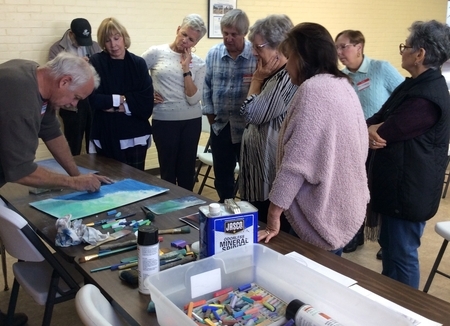 Members move for a closer look as Casimir adds more pastel layers to the curl of a wave at the November 2019th meeting.